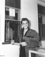 1956 Aug 18_Elvis receiving his first pay check from 20th Century Fox Gettyimages.jpg